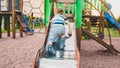 Image of happy smiling cheerful toddler boy riding and climbing on the big children playground at park Royalty Free Stock Photo