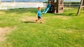Image of happy smiling and laughing toddler boy running on green grass at children playground Royalty Free Stock Photo