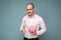 Photo of happy smiling young handsome blond man with sincere emotions wearing casual white shirt isolated over blue Royalty Free Stock Photo