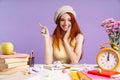 Photo of happy student girl pointing finger sitting with exercise books Royalty Free Stock Photo