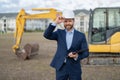 photo of happy supervisor with business project in hardhat. supervisor with business project.