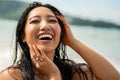 Photo of happy young asian woman with beautiful, big toothy smile. Girl with wet hair enjoying sunny day on the beach. Happy Royalty Free Stock Photo