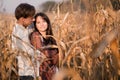 Happy young couple in autumn corn field Royalty Free Stock Photo