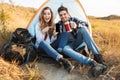 Happy young loving couple outside in free alternative vacation camping drinking hot tea Royalty Free Stock Photo