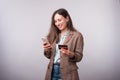 Photo of happy young woman in casual using mobiel phone and holding credit card