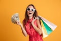 Photo of happy young woman in sunglasses holding fan of money an Royalty Free Stock Photo