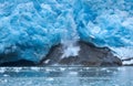 A block of ice falls off and the vertically sloped glacier tongue of Northwestern Glacier (second of four photos).