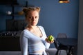 Photo of healthy lovely young caucasian calm woman with natural makeup holding green apple over dark stylish modern Royalty Free Stock Photo