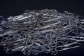 Heap of metal note paper clips on dark background, High details with high contrast