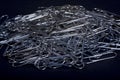 Heap of metal note paper clips on dark background, High details with high contrast Royalty Free Stock Photo