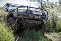 Photo of heavy off-road racing car overcomes hard pit.