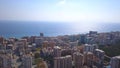 Photo from a helicopter. Clip. A beautiful landscape where you can see the blue sea, the sun, the sky and high-rise