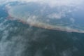 Photo from a high altitude, clouds over the forest and seashore in Kaberneeme