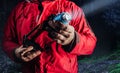 Hiker in red jacket holding flashlight Royalty Free Stock Photo