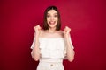 Photo of hooray brown hairdo millennial lady hands fists wear white bare shoulders top isolated on red color background