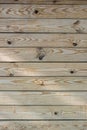 A photo of horizontal boards not varnished or painted as a fragment of a fence for the background.