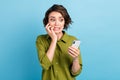 Photo of horrified lovely lady short hairdo arms hold telephone gnaw bite nail horrified look screen wear green shirt