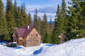 House in winter against the background of fir trees Royalty Free Stock Photo