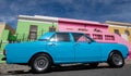 Photo of houses in the Malay Quarter, Bo-Kaap, Cape Town, South Africa with vintage Ford Cortina car outside on street.