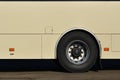 Photo of the hull of a large and long yellow bus with free space for advertising. Close-up side view of a passenger vehicle for t Royalty Free Stock Photo