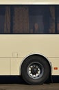 Photo of the hull of a large and long yellow bus with free space for advertising. Close-up side view of a passenger vehicle for t Royalty Free Stock Photo
