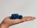 Photo of human hand with miniature car  on white background. Royalty Free Stock Photo