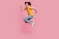 Photo of hurry funky crazy brunette woman jump rush side wear casual jeans clothes on pink background