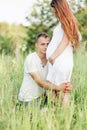 Happy husband embraces his wife`s pregnant belly