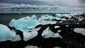 Photo of icebergs cast away on dark beach