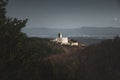 Photo of Illuminated castle with wall on right side in Slovakia - Europe Podhradie. Image of ruins with village on background