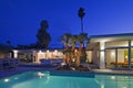 Illuminated patio at poolside in luxurious villa at night