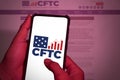 This photo illustration the Commodity Futures Trading Commission (CFTC) logo screen smartphone