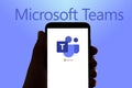 In this photo illustration the logo of the remote team work app Microsoft Teams is seen on the screen of mobile phone and of a lap