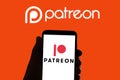 In this photo illustration the logo of the social network patreon seen on the screen of mobile phone and of a laptop in Barcelona