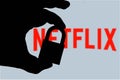 In this photo illustration a man holds a padlock and in the background the logo of Netflix on the computer screen. Online data