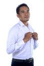 Photo image of a handsome attractive young Asian businessman dressing, button up his shirt