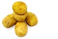On a white background is the potato peeled, washed with water, the color of yellow-brown, different shape, oval, round, light back