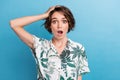 Photo of impressed astonished girl with bob hairstyle dressed colorful blouse arm on head staring isolated on blue color Royalty Free Stock Photo