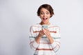 Photo of impressed excited young woman dressed striped pullover holding looking modern device isolated grey color