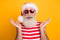 Photo of impressed funky elderly guy wear new year swimsuit hat sunglass rising hands going journey isolated yellow Royalty Free Stock Photo