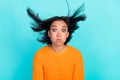 Photo of impressed funky girl dressed orange pullover bloated cheeks air blowing isolated teal color background