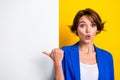 Photo of impressed funny lady dressed blue blazer pointing thumb white wall placard empty space isolated yellow color