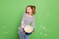 Photo of impressed funny small schoolgirl dressed striped sweater popcorn exploding isolated green color background