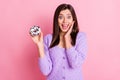 Photo of impressed girl hold donut hand face wear lilac sweater isolated on pink color background