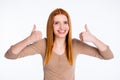 Photo of impressed sweet redhair woman beige shirt showing two thumb up smiling isolated white color background Royalty Free Stock Photo