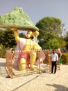 Photo of an Indian man with the statue of our Lord Hanuman