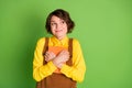 Photo of inspired funny girl embrace book look empty space wear yellow shirt overall isolated green color background Royalty Free Stock Photo