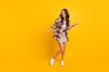 Photo of inspired lady dance look empty space wear plaid coat mini skirt sneakers isolated yellow color background Royalty Free Stock Photo