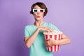 Photo of interested young woman dressed casual turquoise clothes 3d cinema eyeglasses eating popcorn  violet Royalty Free Stock Photo