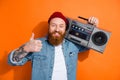 Photo of irish funny redhair guy thumb up dj music lover hold boom box retro party bearded tattooed person isolated on